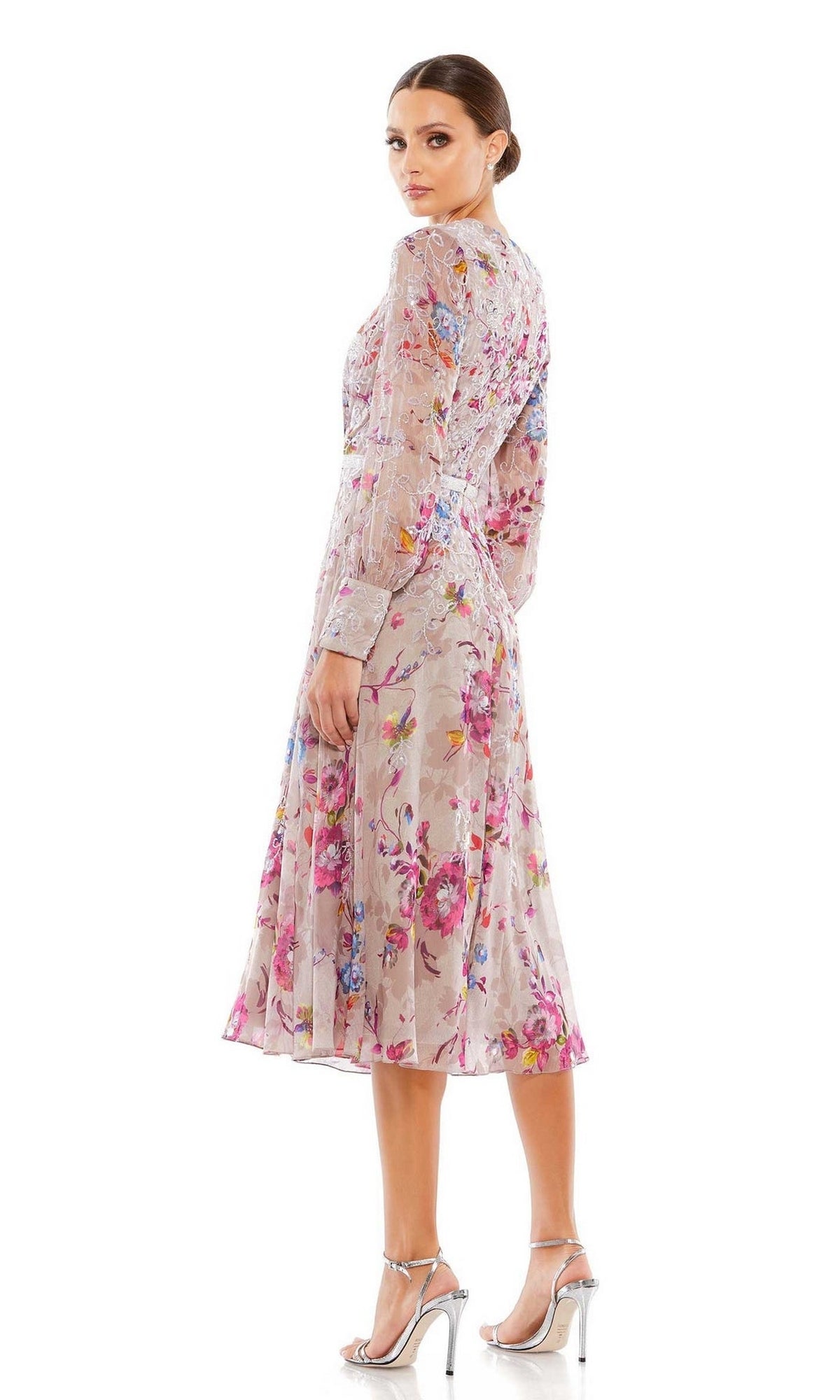 Woman in the Mac Duggal 9147 Mauve Print Wedding Guest Dress, featuring long sleeves, a sheer overlay, and midi length, poses in silver heels against a white background.
